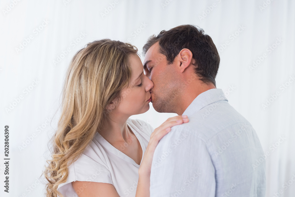 Close-up side view of a loving couple kissing Close-up side view of a loving couple kissing