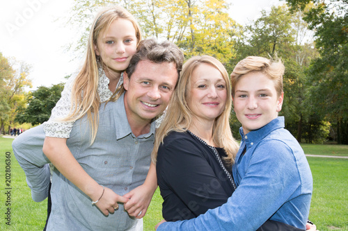 Happy young family spending time together outside in green nature