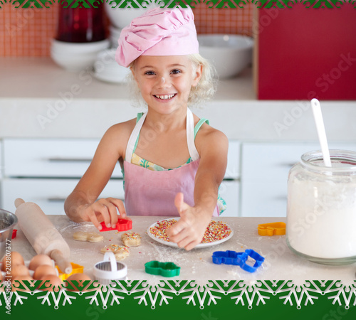 Lovely girl baking in a kitchen against snowflake frame