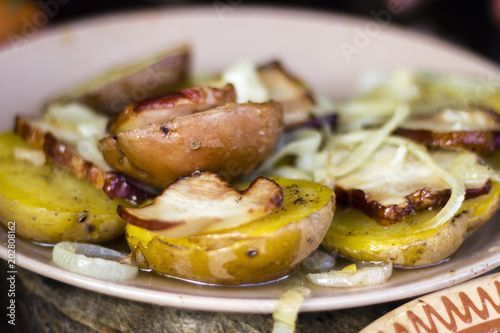 Grilled potatoes with lard and onion