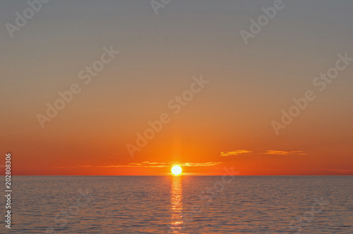 Sunset over the Sea. Beautiful Sunset over the flat horizon © makeitanyway