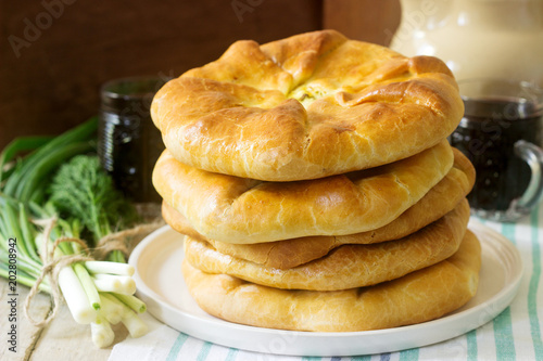 Traditional homemade Romanian and Moldovan pies - Placinta, served with wine. Rustic style.
