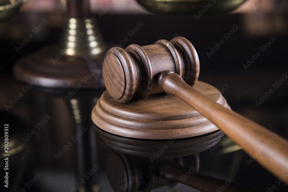 Law theme, mallet of the judge, justice scale, mirror reflection background
