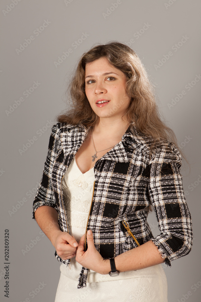 Fashion photo of a young woman with curly hair wearing white dress and jacket Fashion photo of a young woman with curly hair wearing white dress and jacket