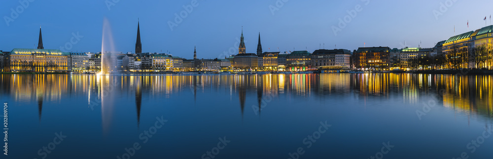 Naklejka premium Beautiful panoramic view of Hamburg town hall - Rathaus and Alster river at spring earning evening during blue hour