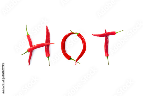 hot word written with red chili peppers on white background abstract concept photo