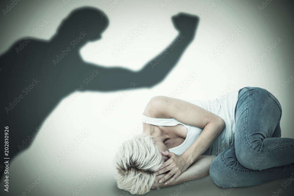 Φωτογραφία Sad blonde woman lying on the floor  against silhouette of cheering sportsman
