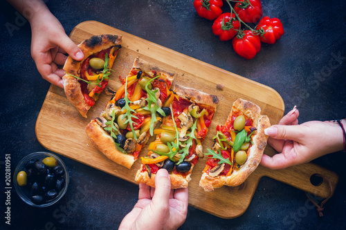 Family sharing fresh homemade vegetarian pizza 