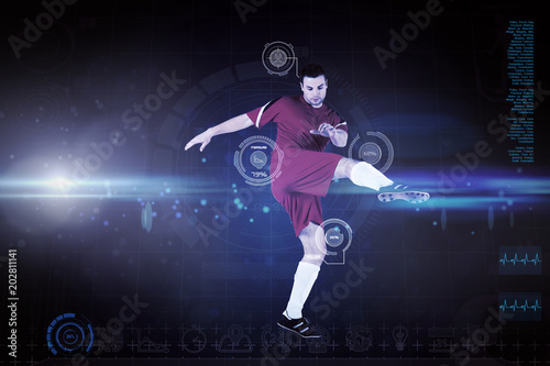 Football player in red kicking against blue dots on black background