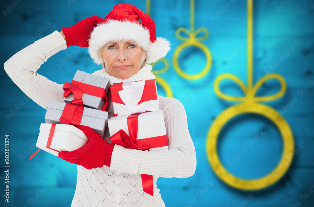Obraz premium Festive woman holding gifts against blurred christmas background