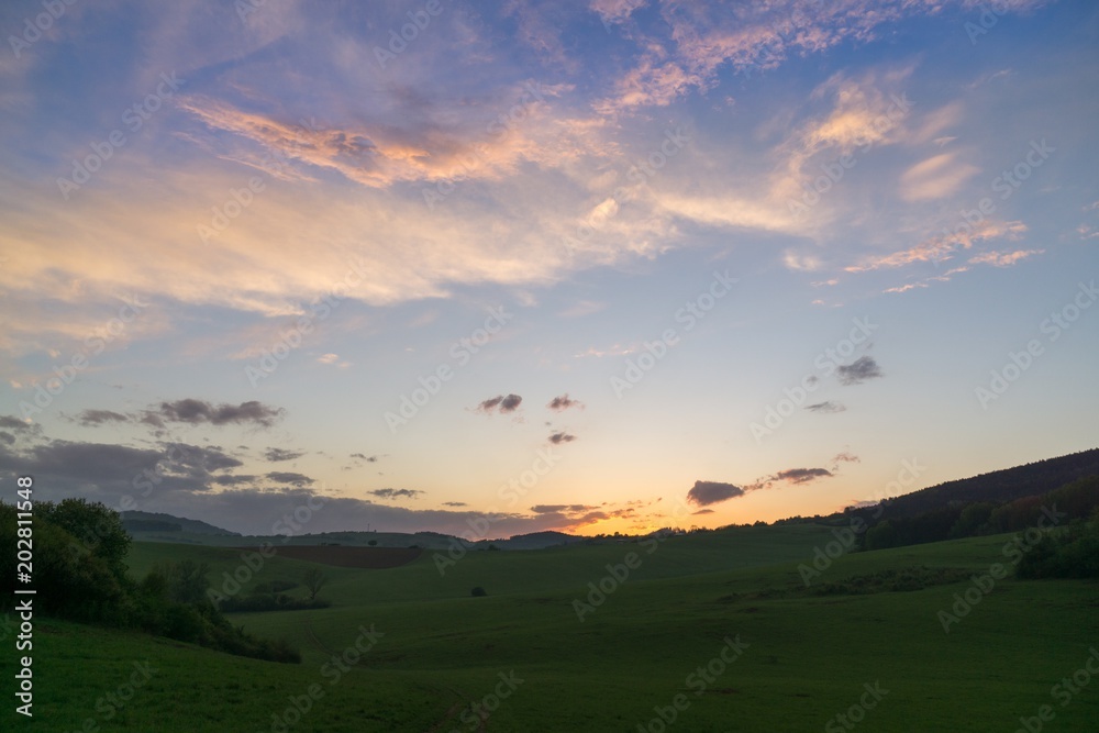 Sunset on meadow with hills and tree. Slovakia
