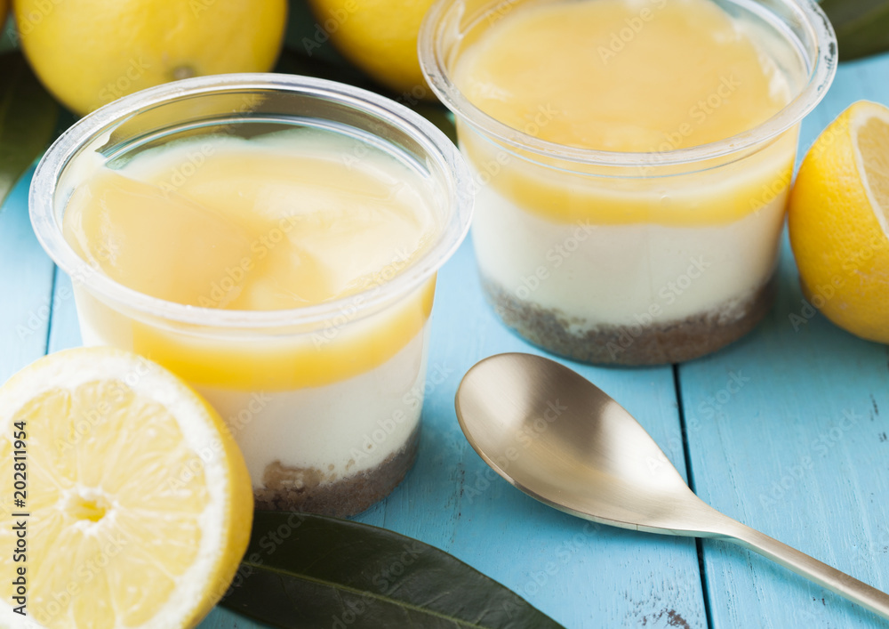 Plastic cups with lemon cream and biscuit dessert Plastic cups with lemon cream and biscuit dessert