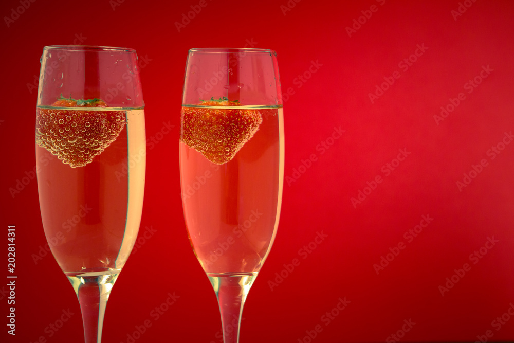 Two glasses of champagne with strawberries Two glasses of champagne with strawberries