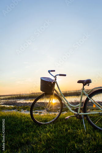 Bike on the shore of the lake at sunset