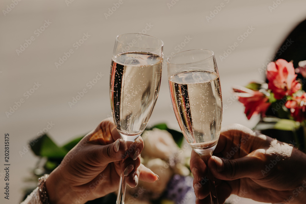 Φωτογραφία Bride and groom toast and clink glasses with champagne, celebrate wedding in restaurant