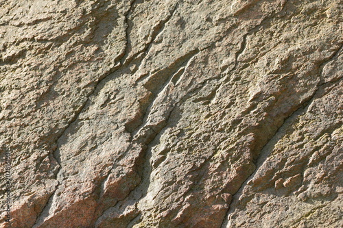 Natural stone granite texture, granite pattern. Stone background of mottled granite igneous rock used for kitchen worktops etc. Surface of the marble with brown tint