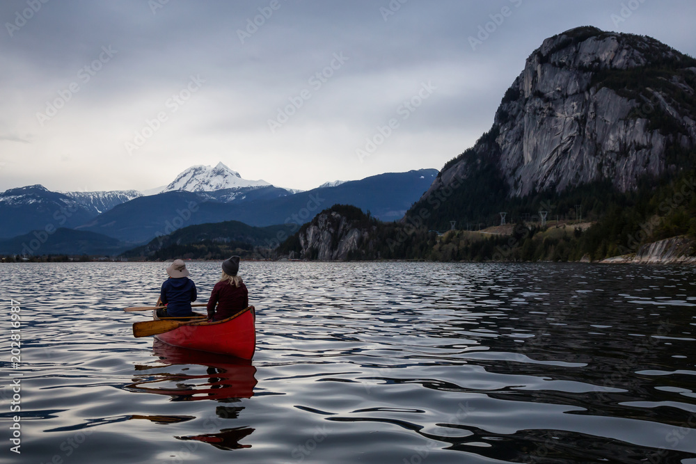 Adventurous people on a canoe are enjoying the beautiful Canadian Mountain Landscape. Taken in Squamish, North of Vancouver, British Columbia, Canada. Adventurous people on a canoe are enjoying the beautiful Canadian Mountain Landscape. Taken in Squamish, North of Vancouver, British Columbia, Canada.