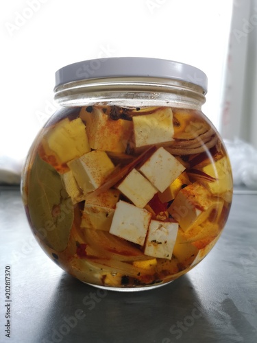 Glass jar with fitaki cheese in oil  photo