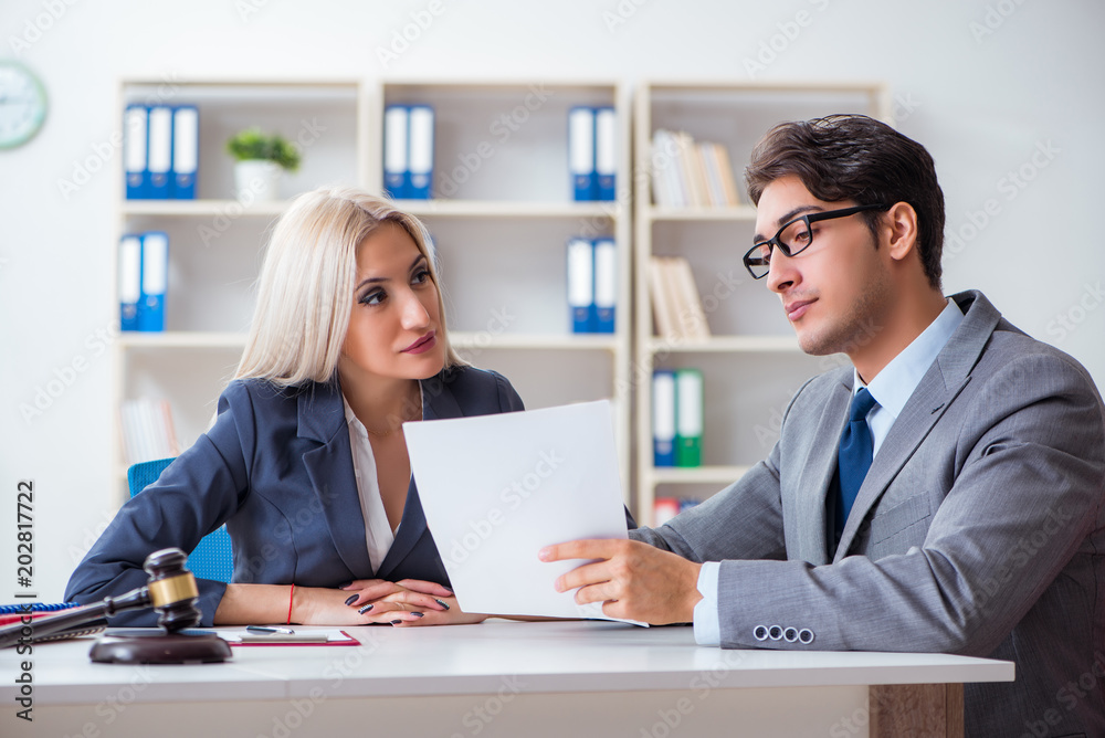 Lawyer discussing legal case with client Lawyer discussing legal case with client