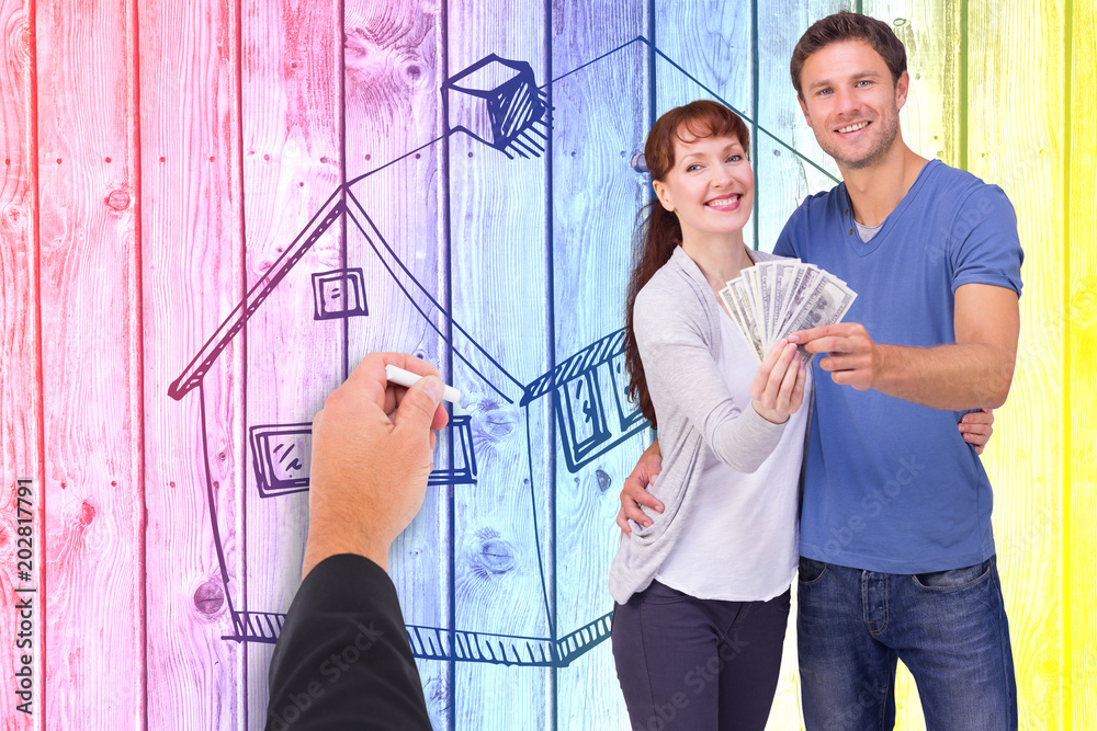 Φωτογραφία Couple holding fan of cash against digitally generated grey wooden planks