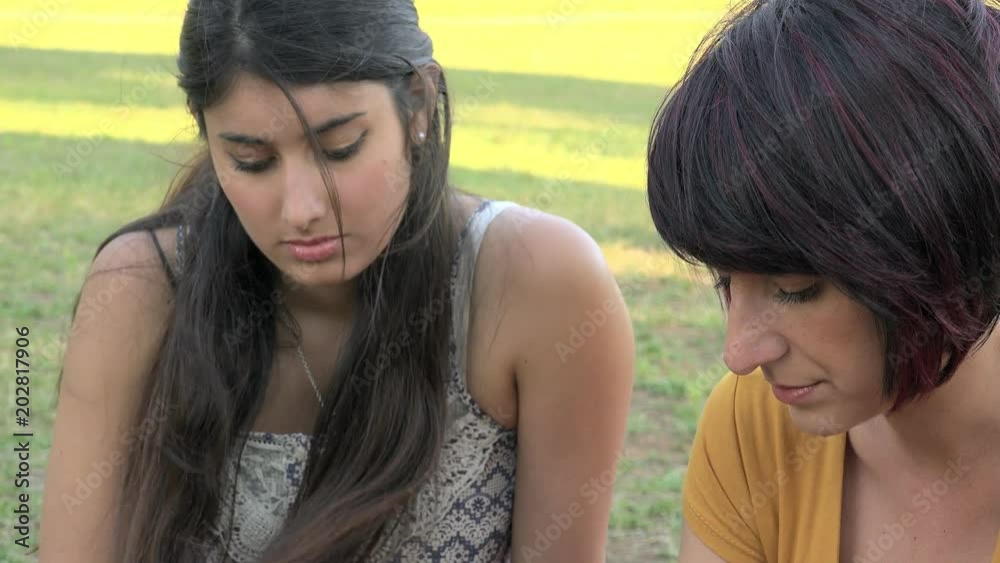 focus on Female, Friendship, support- Young Girlfriends Have Serious Conversation And Hug
