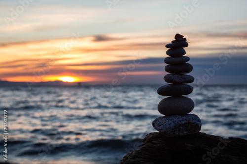 Stack of Rocks piled up by the ocean during a sunny sunset. Taken in Wreck Beach, Vancouver, British Columbia, Canada.