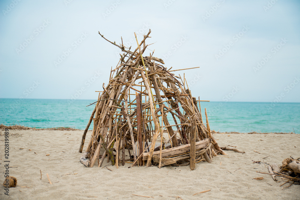 robinson crusoe refugee handmade shelter by the sea in abandoned shore of isolated island robinson crusoe refugee handmade shelter by the sea in abandoned shore of isolated island