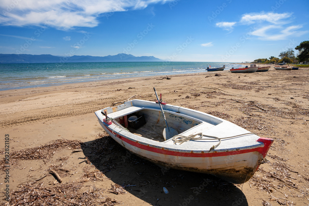 Lonely fisherboat at the coast of Kavos in Corfu, Greece