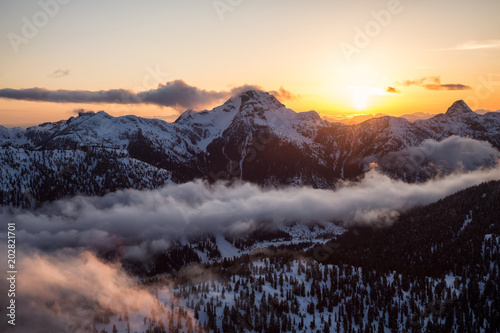 Striking and beautiful aerial landscape view of Canadian Mountains during a vibrant sunsetd. Taken North of Vancouver, British Columbia, Canada. © edb3_16