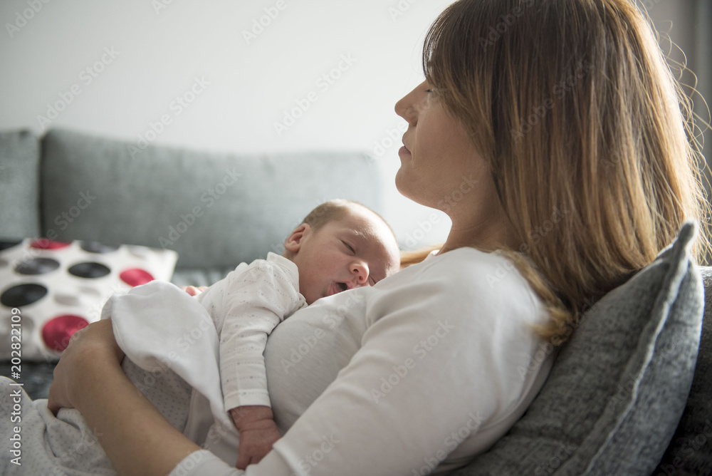 Young Mother Caring for her First Baby Boy - obrazy, fototapety, plakaty 