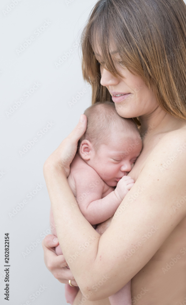 Young Mother Caring for her First Baby Boy Young Mother Caring for her First Baby Boy