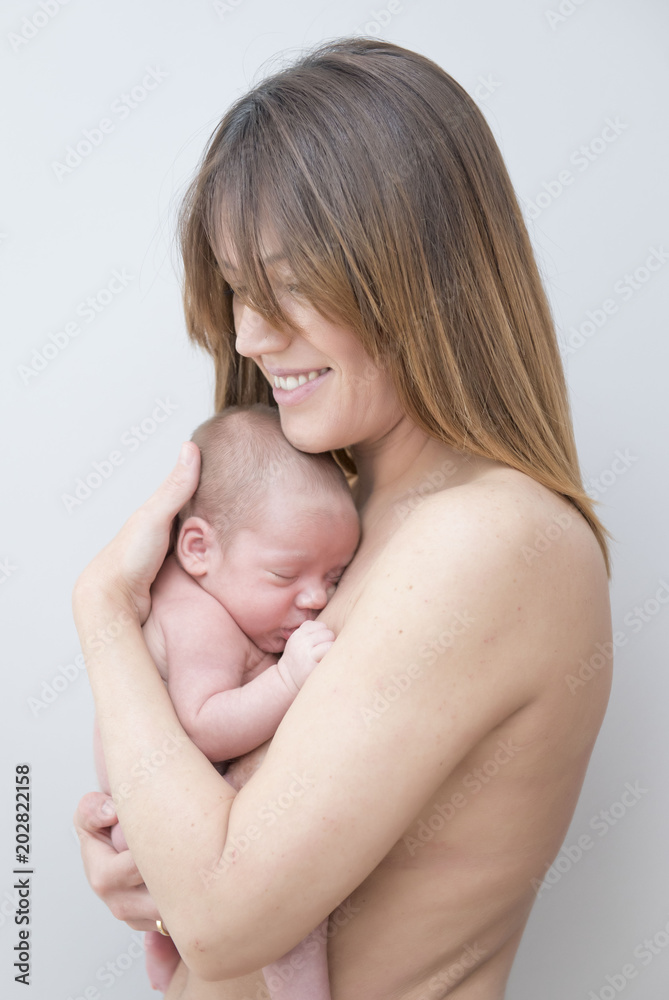 Young Mother Caring for her First Baby Boy Young Mother Caring for her First Baby Boy