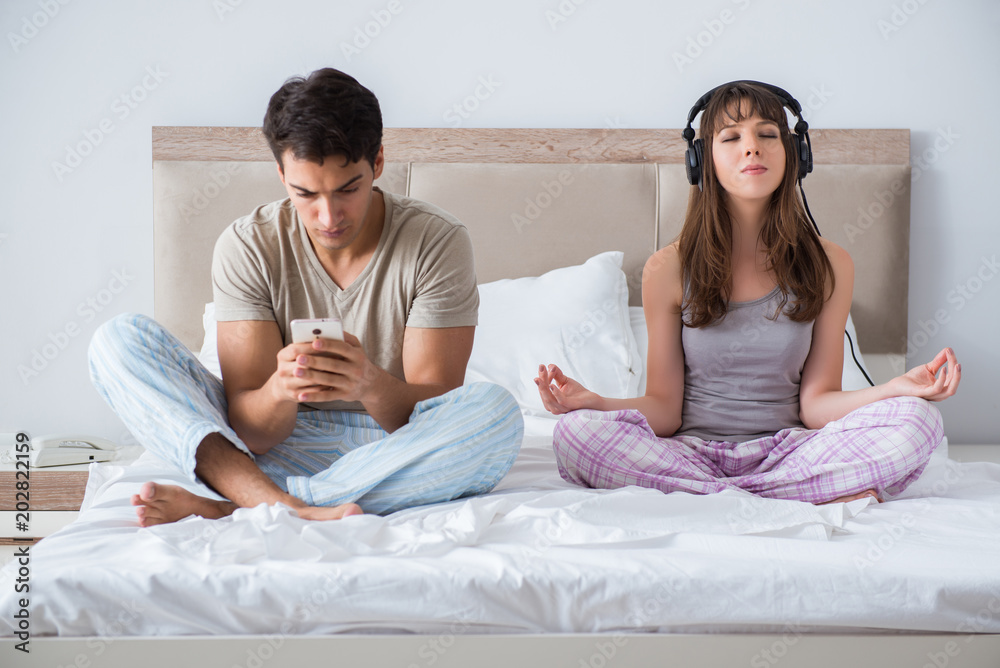 Young family meditating in the bed bedroom Young family meditating in the bed bedroom