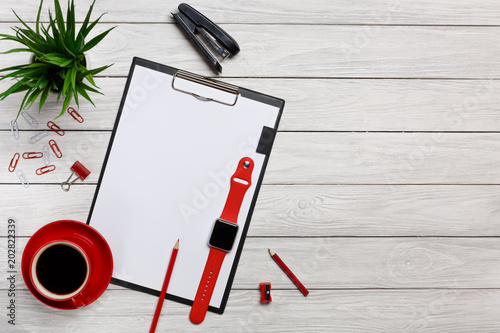 white table boards folders red notebook cup morning coffee clock paper clips keyboard mouse office worker office