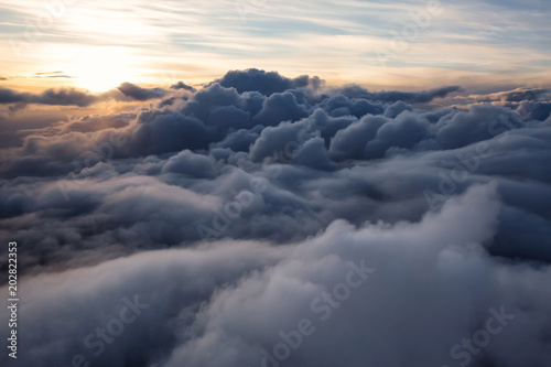 Photography Beautiful and striking aerial view of the puffy clouds during a colorful sunset