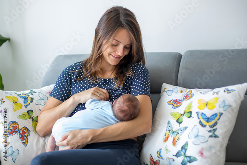 Young mother breastfeeding  her newborn baby boy