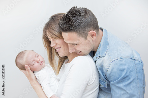 Young Couple Posing Happy with their first child © Noelia