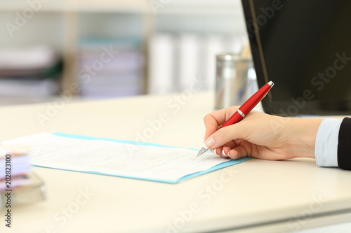 Executive hand signing a form or contract