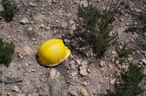 Yellow helmet on the ground photo
