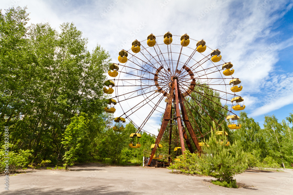 The abandoned Ferris wheel in the amusement park in a dead city Pripyat, Ukraine. Chernobyl nuclear power plant zone of alienation