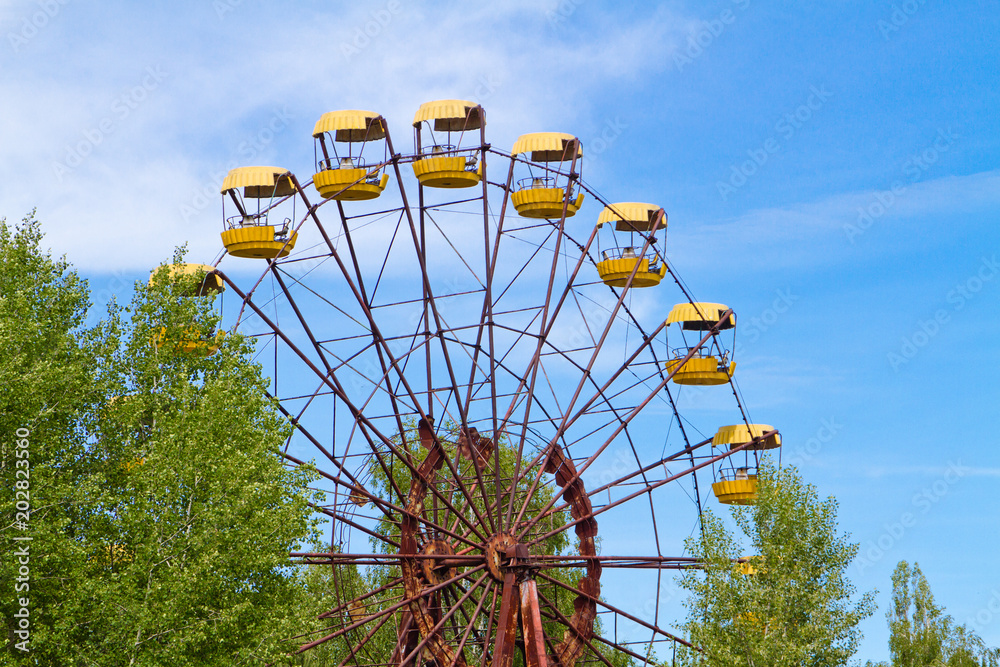 The abandoned Ferris wheel in the amusement park in a dead city Pripyat, Ukraine. Chernobyl nuclear power plant zone of alienation The abandoned Ferris wheel in the amusement park in a dead city Pripyat, Ukraine. Chernobyl nuclear power plant zone of alienation