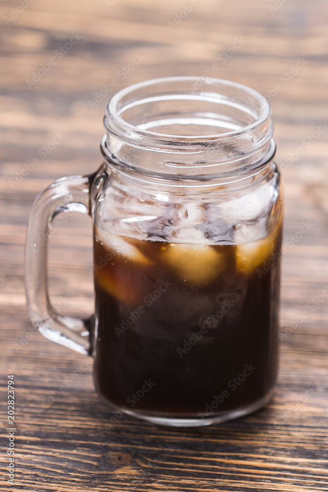 Ice coffee and coffee beans on the background. Ice coffee and coffee beans on the background.
