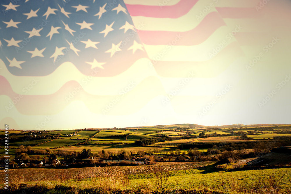 Fotografie Rippled US flag against scenic landscape