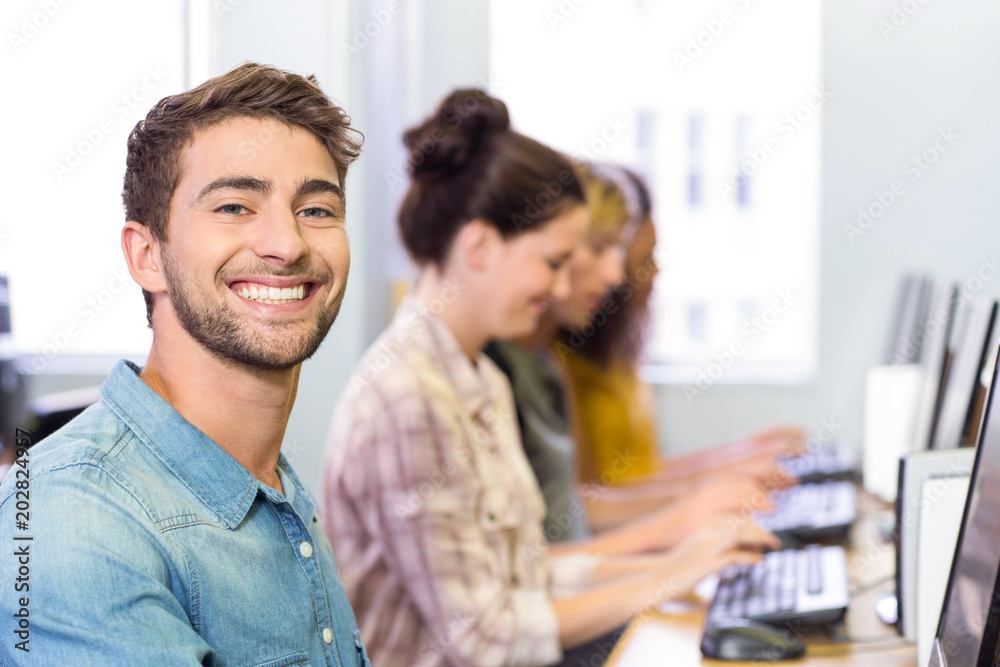 Student smiling at camera in computer class Student smiling at camera in computer class