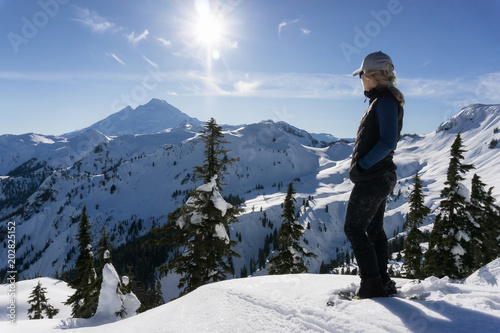 Adventurous woman is snowshoeing in the beautiful mountainous landscape. Taken in Artist Point, Northeast of Seattle, Washington, United States of America. © edb3_16