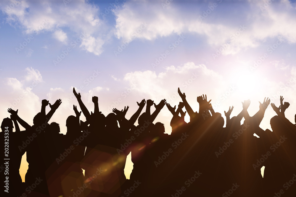 Silhouetters celebrating against sun shining Silhouetters celebrating against sun shining