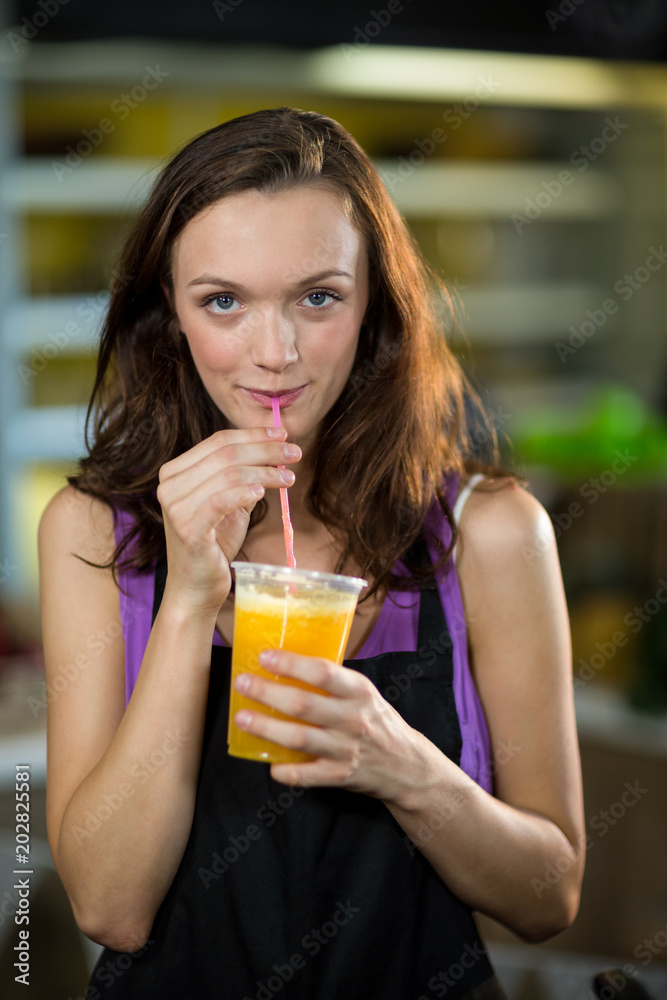 Shop assistant having fresh fruit juice Shop assistant having fresh fruit juice