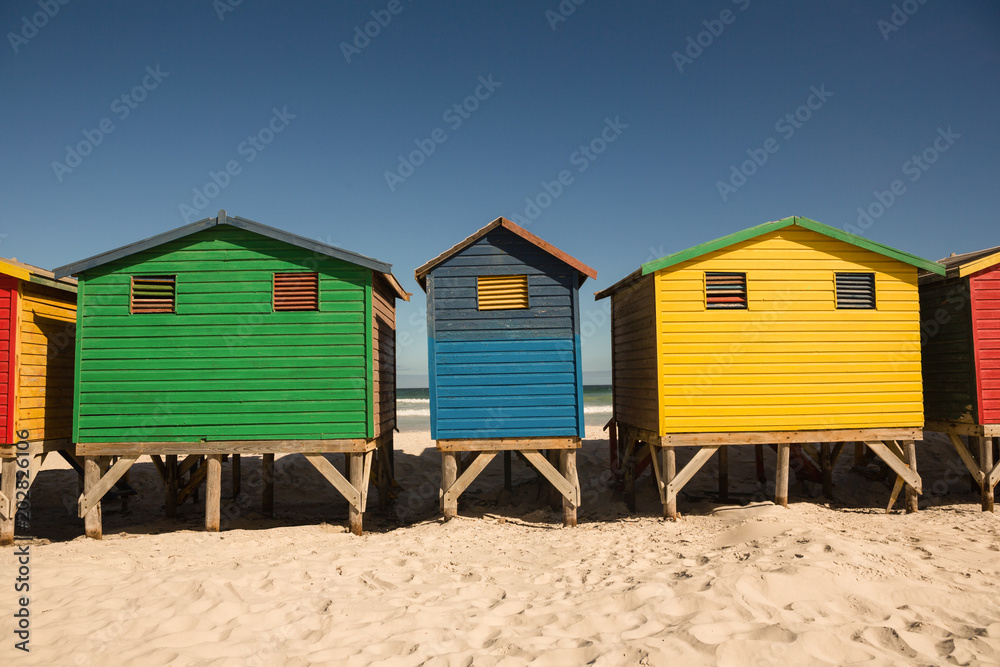 Colorful houses on sand against clear sky Colorful houses on sand against clear sky