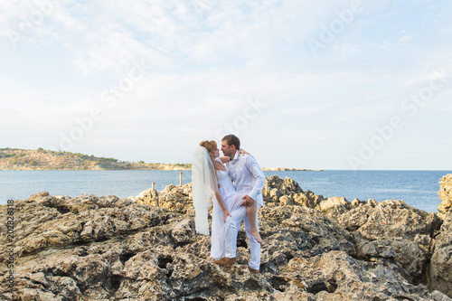 Happy wedding couple on sea beach