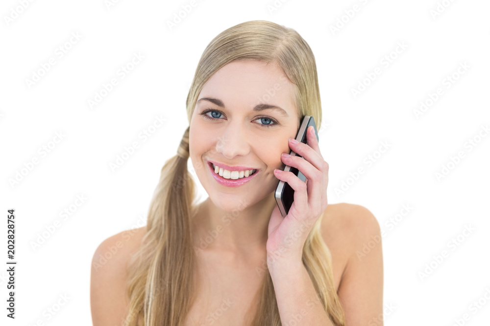 Smiling young blonde woman making a phone call Smiling young blonde woman making a phone call